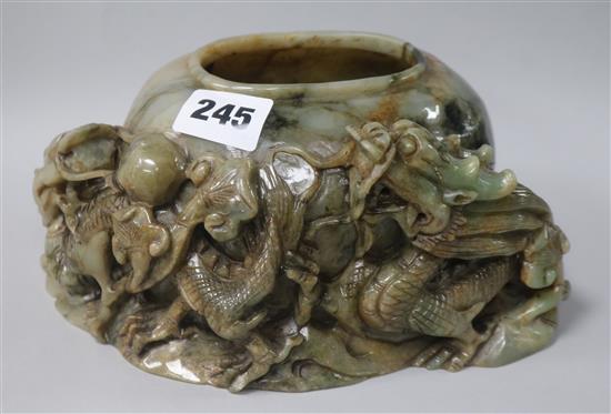 An early 20th century green jade watercoop, carved with two dragons, frame in pearl, rocks and fungus  W.20cm